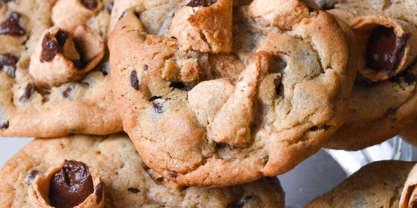 Chocolate chip cookies topped with Muddy Bites waffle cone snacks on a platter