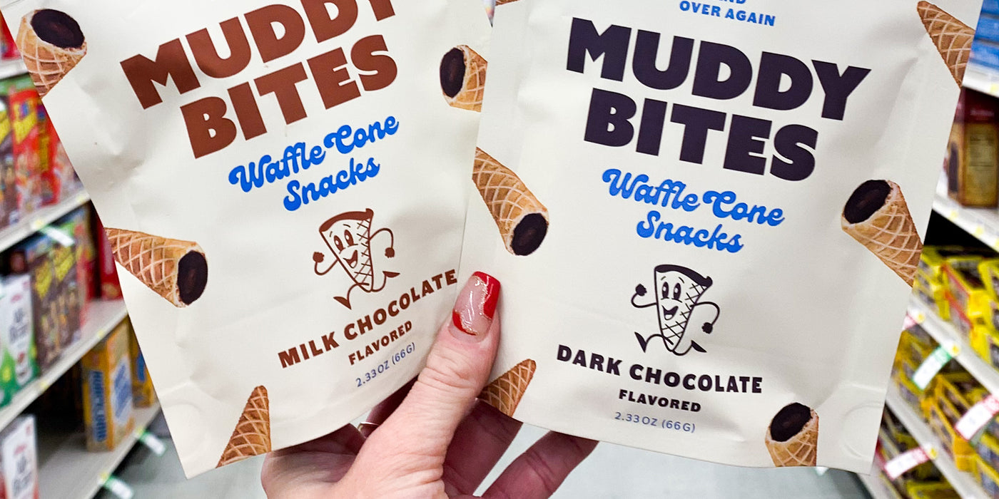 Milk chocolate and dark chocolate Muddy Bites waffle cone snacks held up in a retail store aisle